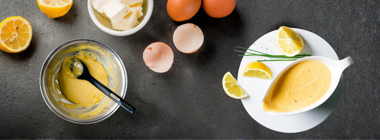Finished hollandaise sauce in a bowl, pale yellow and glossy