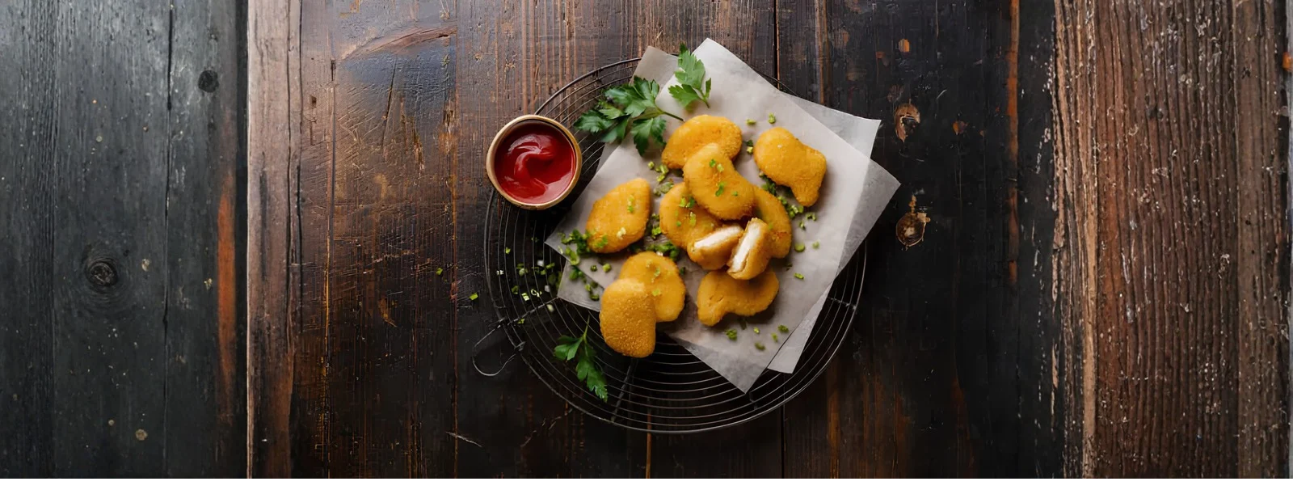 Golden-brown fried food drained on a wire rack