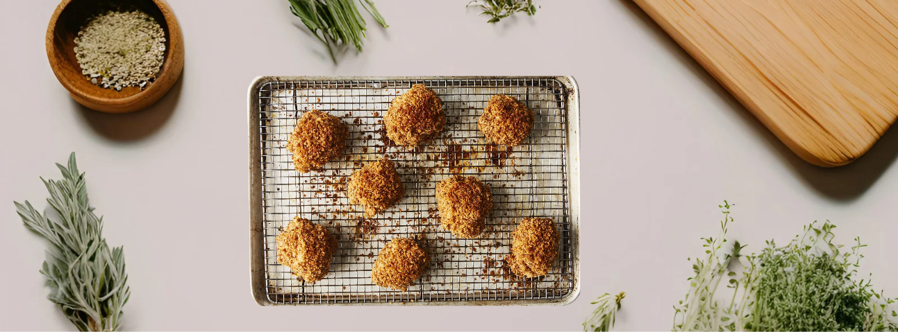 Golden-brown pan-fried chicken cutlet resting on a wire rack