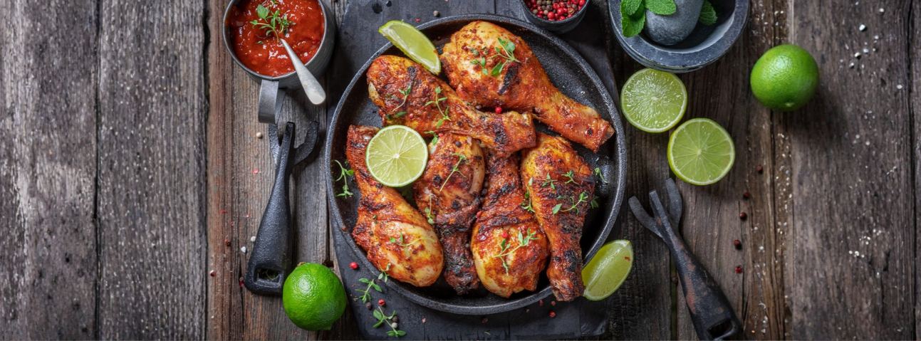 Grilled chicken on a plate, garnished with herbs