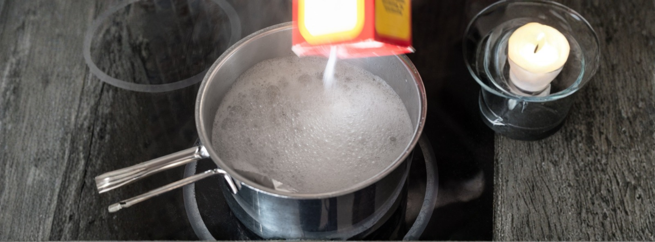 Salt being poured into a pot of water at a rolling boil