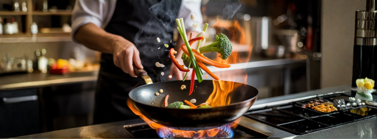 Vegetables stir-frying in a wok over high heat